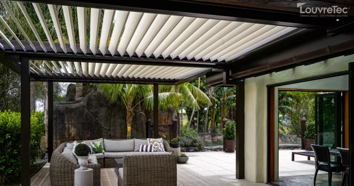 Modern residential patio with a Louvretec opening roof and comfortable outdoor furniture.