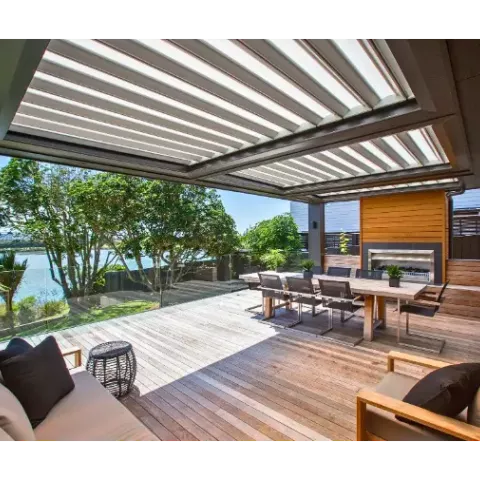 Expansive modern deck with a louvered roof system, outdoor furniture, and ocean views.