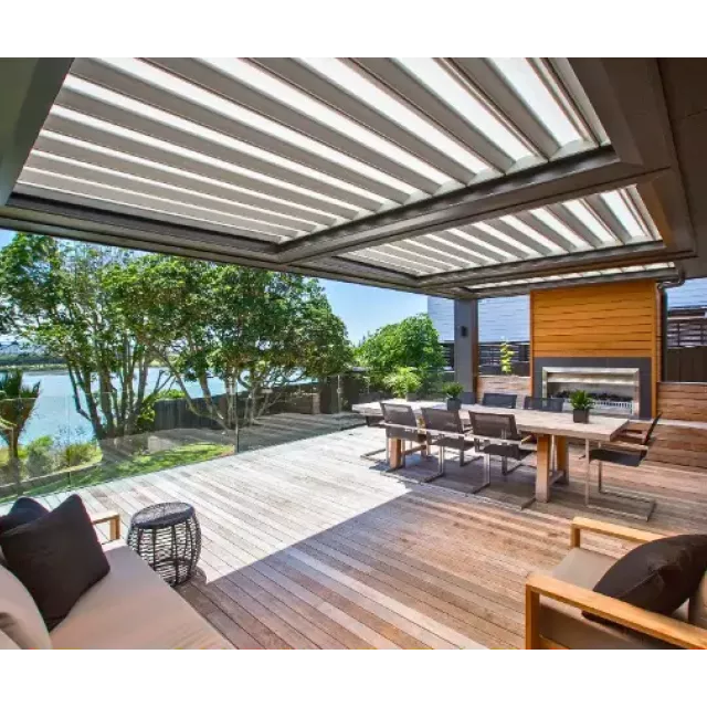 Expansive modern deck with a louvered roof system, outdoor furniture, and ocean views.